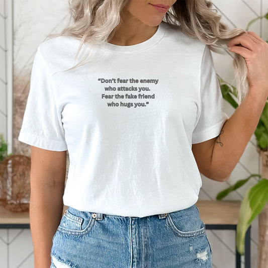 Don’t fear the enemy  who attacks you. Fear the fake friend  who hugs you.”T Shirt